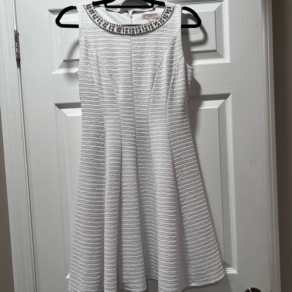 Elegant White Sleeveless Dress with Embellished Neckline